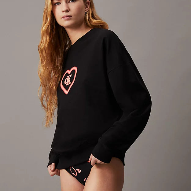Calvin Klein CK96 Womens Lounge Sweatshirt Black side view on model with long hair, featuring logo print and relaxed fit.
