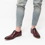 Base London CAST Mens Leather Brogue Shoes Bordo side view with denim jeans, highlighting Oxford shoe style and burgundy color.