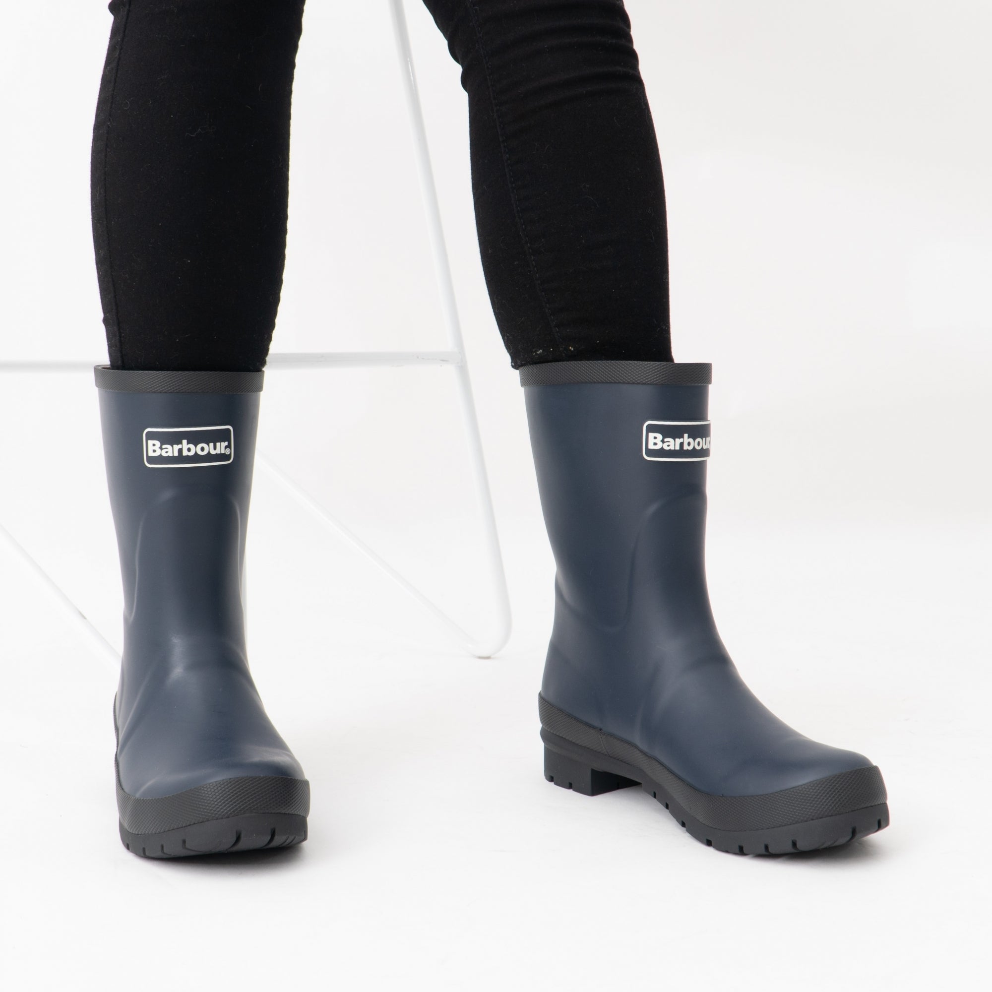 Barbour BANBURY Womens Mid-Calf Wellington Boots Navy front view worn with black jeans, showcasing waterproof rubber construction.