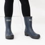 Barbour BANBURY Womens Mid-Calf Wellington Boots Navy front view worn with black jeans, showcasing waterproof rubber construction.