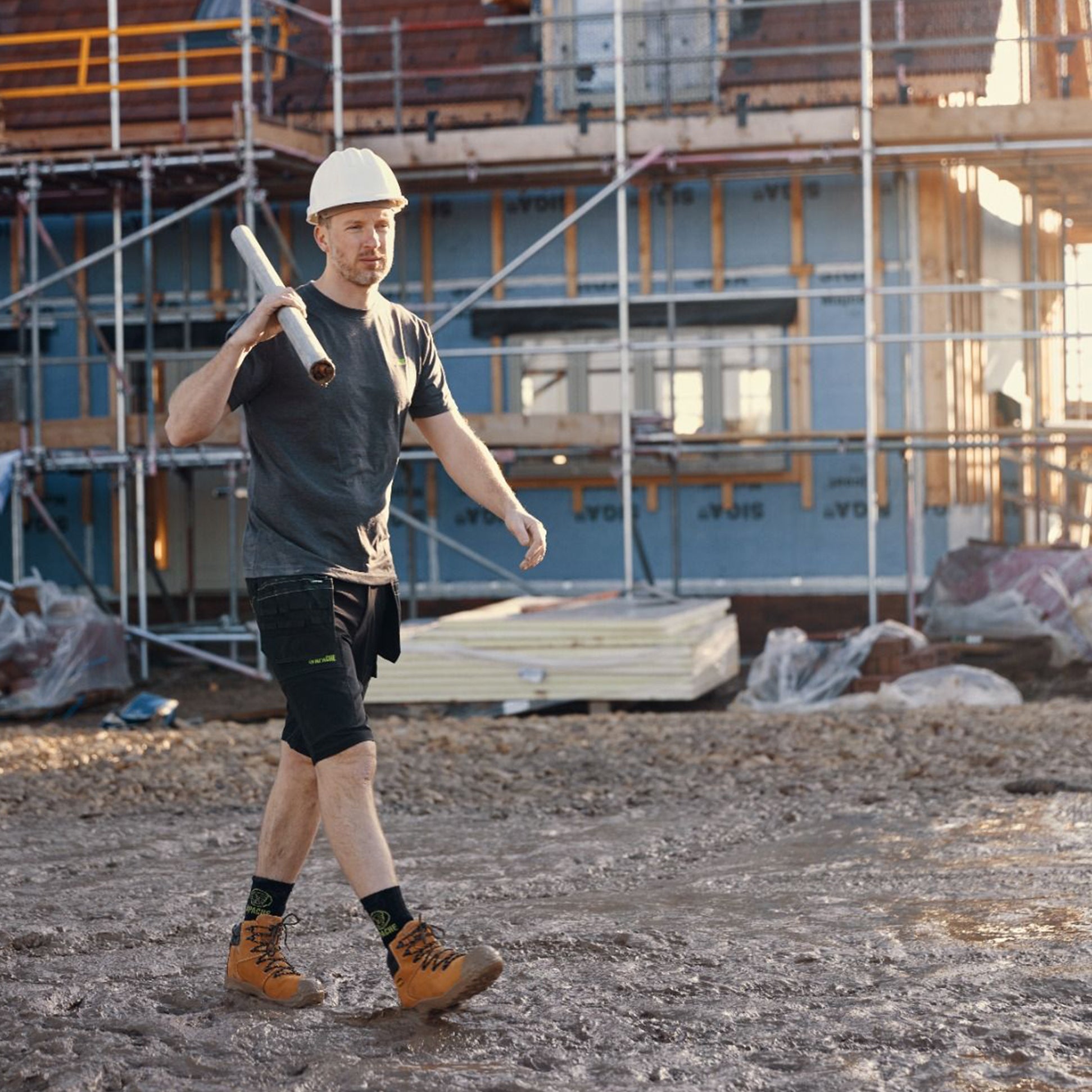Apache AP314CM Mens Boots Wheat worn by a construction worker walking on site, side view, showing safety features and style.