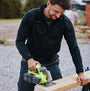 Apache ATS TECH Mens Quarter-Zip Fleece Black, front view of man using a saw, showcasing the fleece's features.
