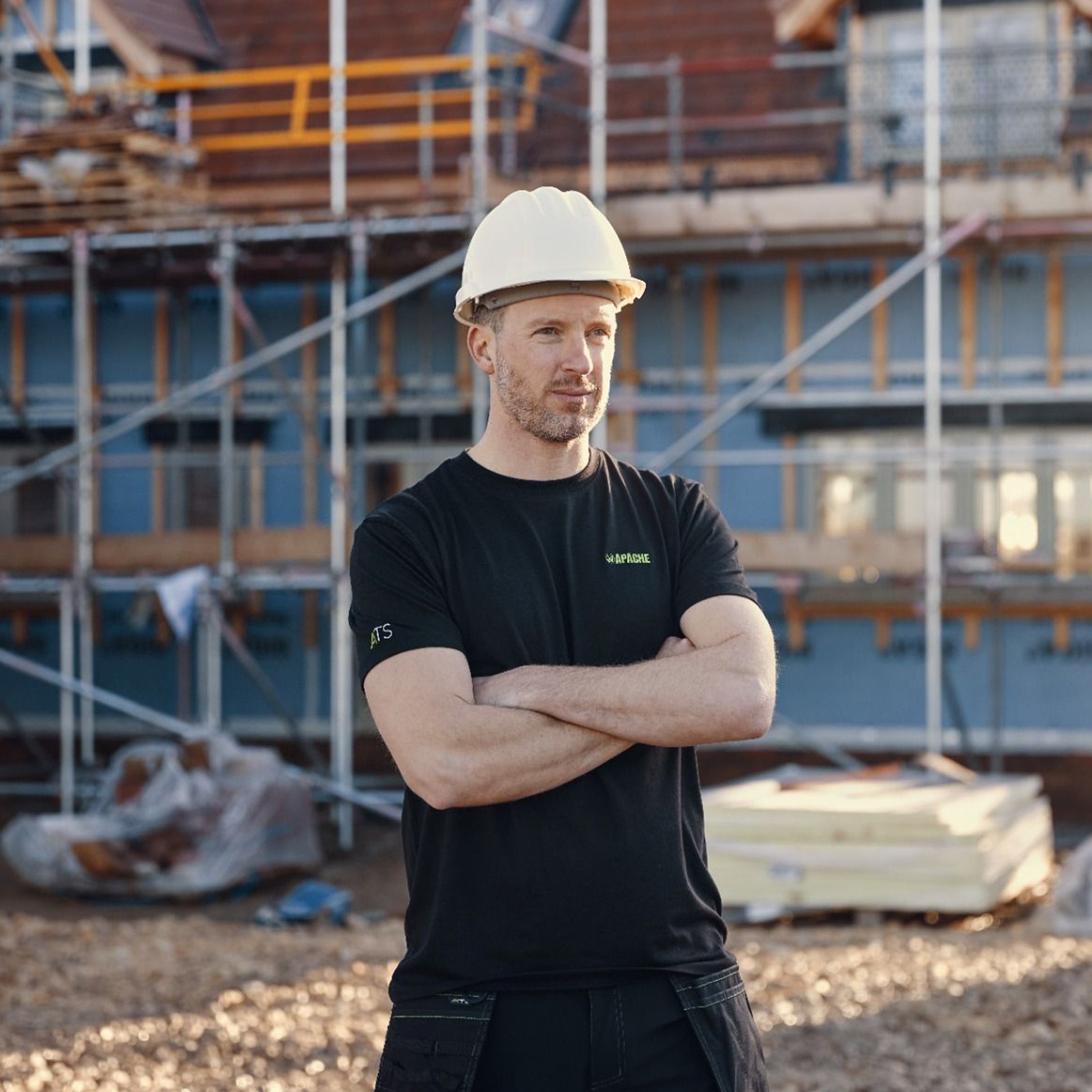 Apache DELTA Mens Workwear T-Shirt Black front view on a model at a construction site wearing a safety helmet.