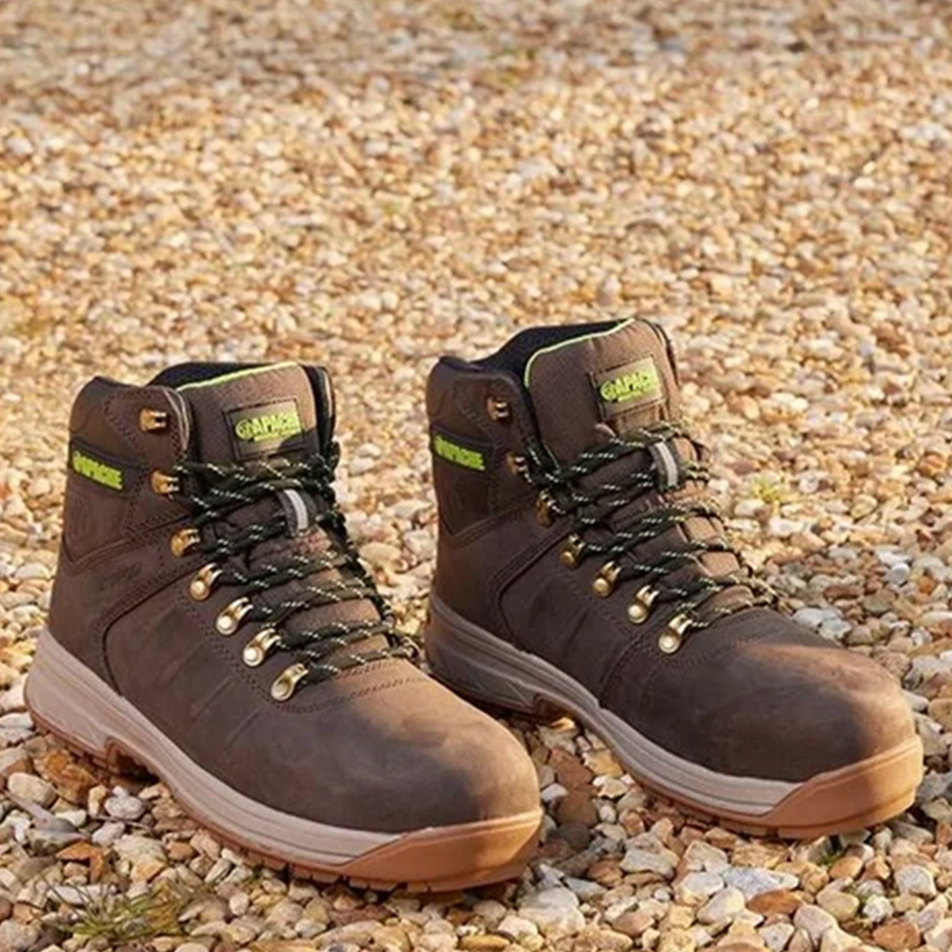 Apache MOOSE Unisex Boots Brown side view showcasing lace-up design and rubber sole on gravel surface.