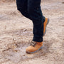 Apache MOOSE Unisex Boots Wheat side view worn in puddle, showcasing lace-up design and durable nubuck upper.