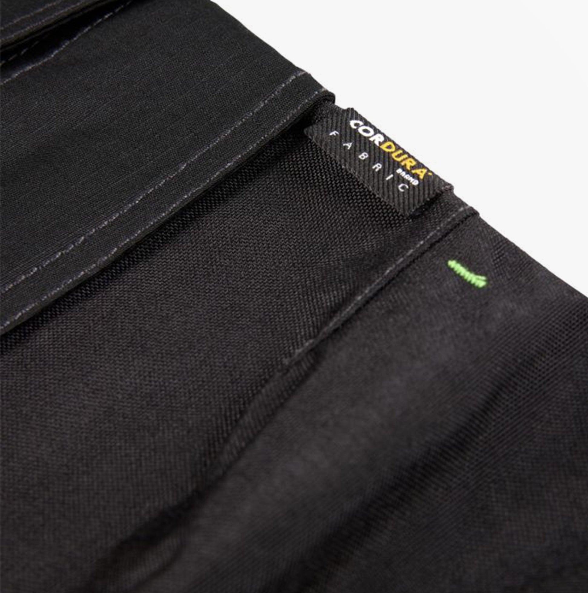 Close-up detail view of Apache SUDBURY Mens Trousers Black showcasing CORDURA fabric label.