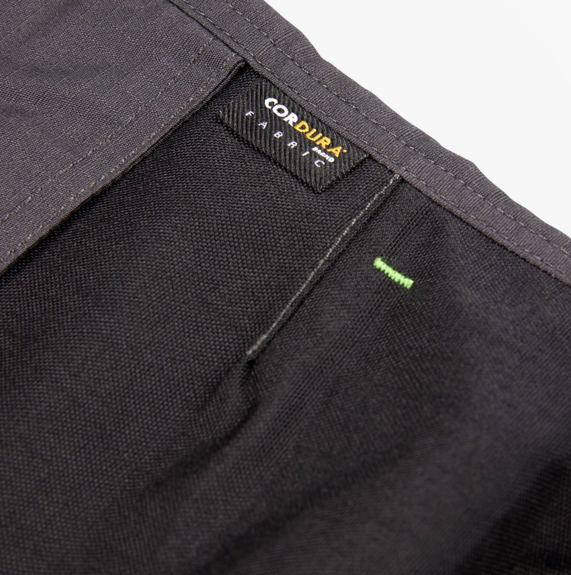 Detail view of Apache SUDBURY Mens Trousers Grey Black showing Cordura fabric label and texture.