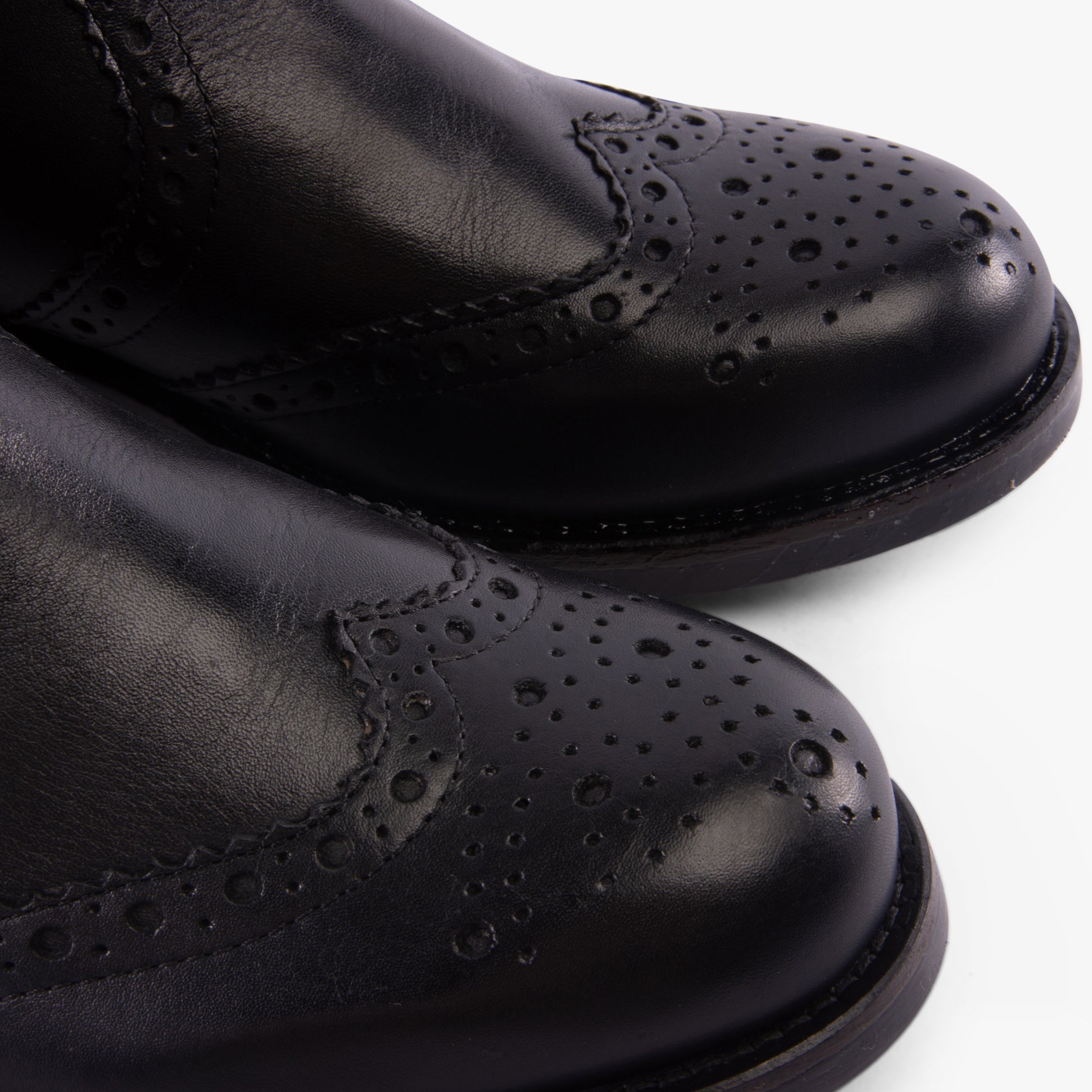 Band Wagon ELGIN Mens Chelsea Boots Black detail view highlighting leather texture and decorative perforations.