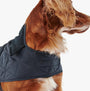 Barbour QUILTED DOG COAT Navy side view on a dog, showcasing the adjustable strap and quilted design.