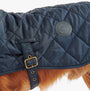 Barbour QUILTED DOG COAT Navy side view with adjustable strap and logo detail.
