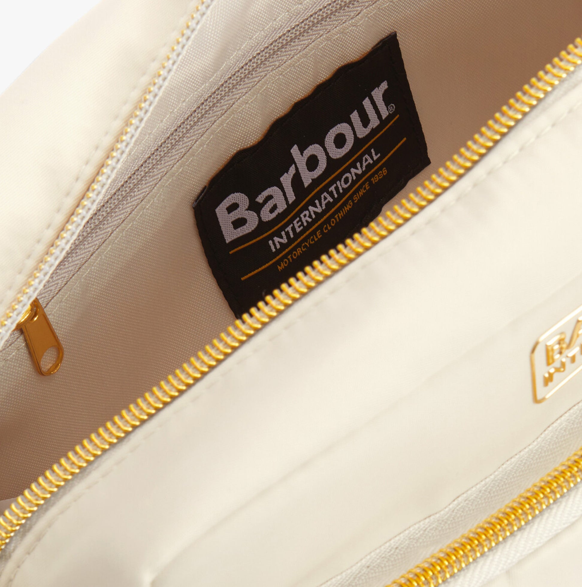 Barbour B.INTL QUALIFY Womens Crossbody Bag Light Pearl interior detail view showing lining and tag