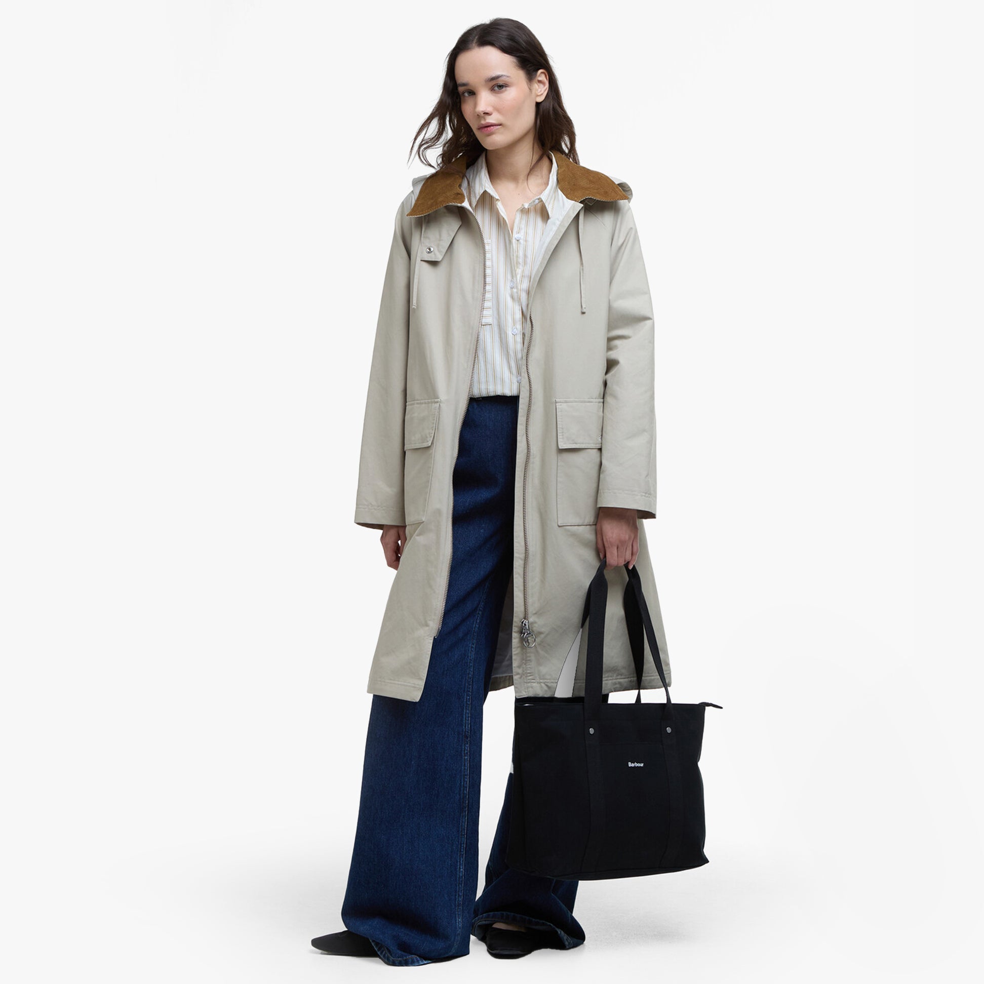 Barbour OLIVIA Womens Backpack Black front view featuring model in casual attire with a beige coat and flared jeans.