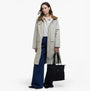 Barbour OLIVIA Womens Backpack Black front view featuring model in casual attire with a beige coat and flared jeans.