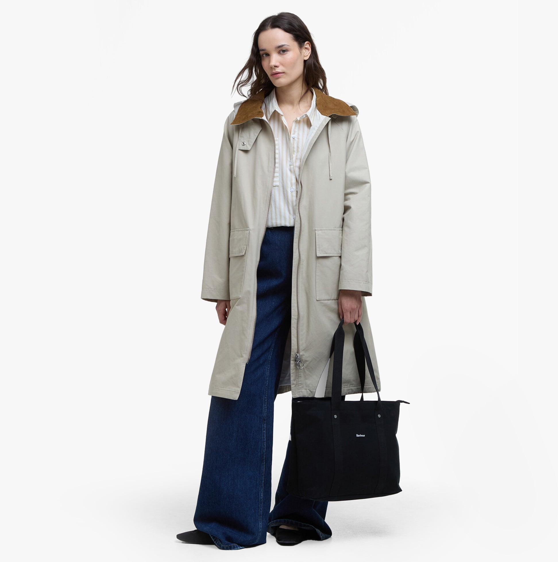 Barbour OLIVIA Womens Backpack Black front view featuring model in casual attire with a beige coat and flared jeans.