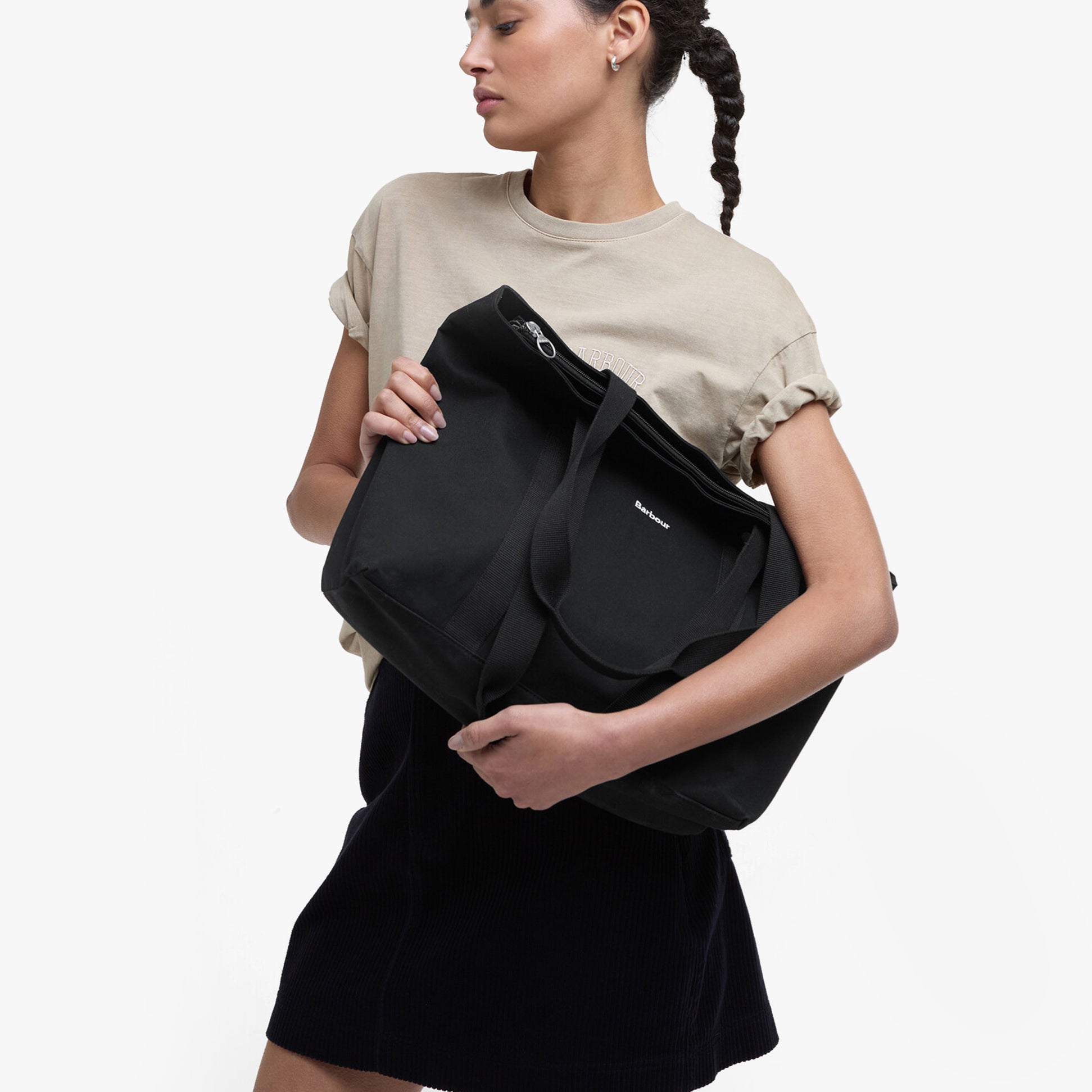 Barbour OLIVIA Womens Tote Bag Black held in model's arms, side view, showcasing stylish and lightweight design.