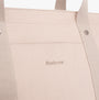 Detail view of Barbour OLIVIA Womens Tote Bag Light Sand showcasing logo and fabric texture.