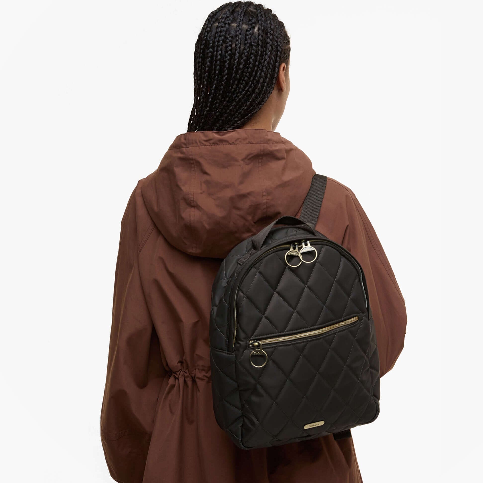 Barbour QUILTED Womens Backpack Olive back view, featuring zip closure and quilted design, worn with a brown jacket.