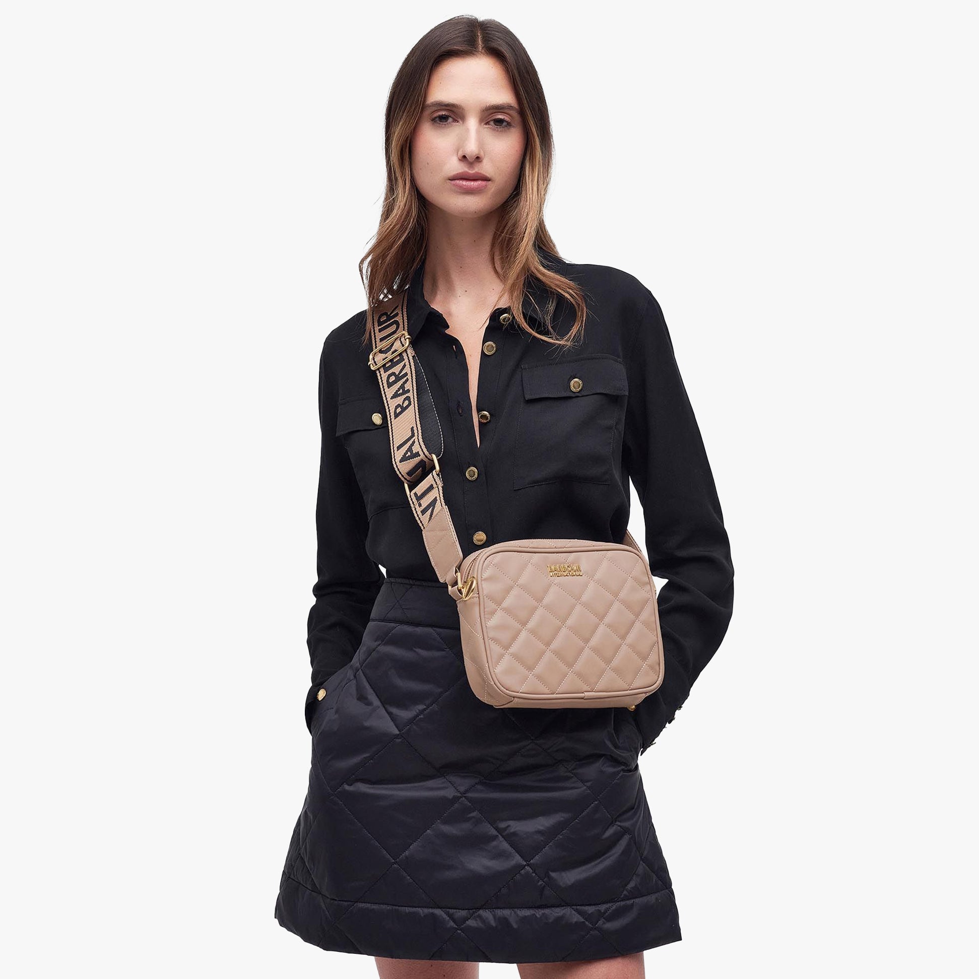 Barbour QUILTED SLOANE Womens Crossbody Bag Camel on model in front view, showcasing adjustable strap and quilted design.