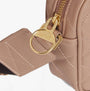Detail view of Barbour QUILTED SLOANE Womens Crossbody Bag Camel with gold zipper and logo charm.