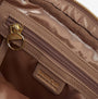 Interior detail view of Barbour QUILTED SLOANE Womens Crossbody Bag Camel showing zip and logo.