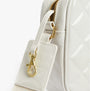 Detail view of Barbour B.INTL QUILTED SLOANE Womens Crossbody Bag Gloss Silver Birch showing zip and strap.