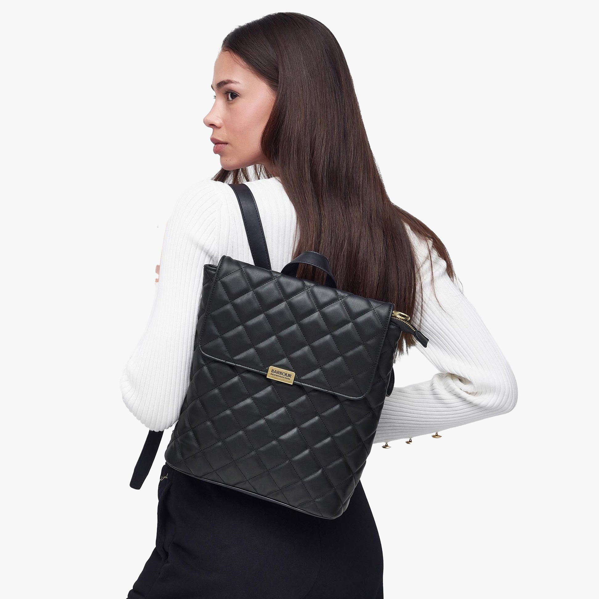 Barbour QUILTED HOXTON Womens Backpack Black side view worn by model, showcasing quilted design and adjustable straps.