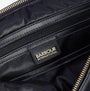 Detail view of Barbour QUILTED HOXTON Womens Backpack Black interior showing logo and zipper details.