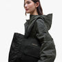 Barbour B.INTL QUALIFY Womens Tote Bag Black on model's shoulder, showcasing sleek design and logo detail.
