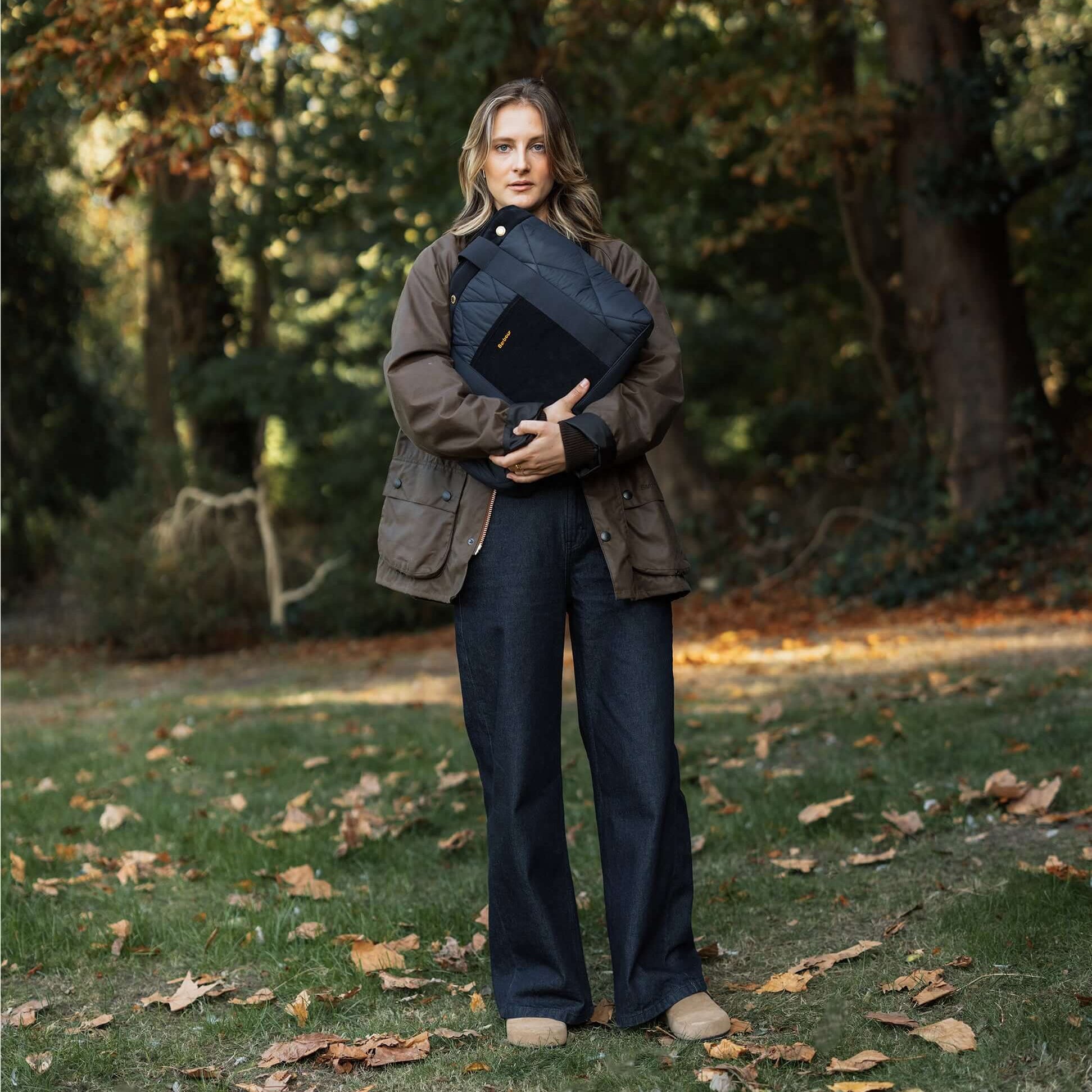Barbour HEALY Tote Bag Womens Tote Bag Navy held by model in outdoor setting, front view showcasing the bag's design.