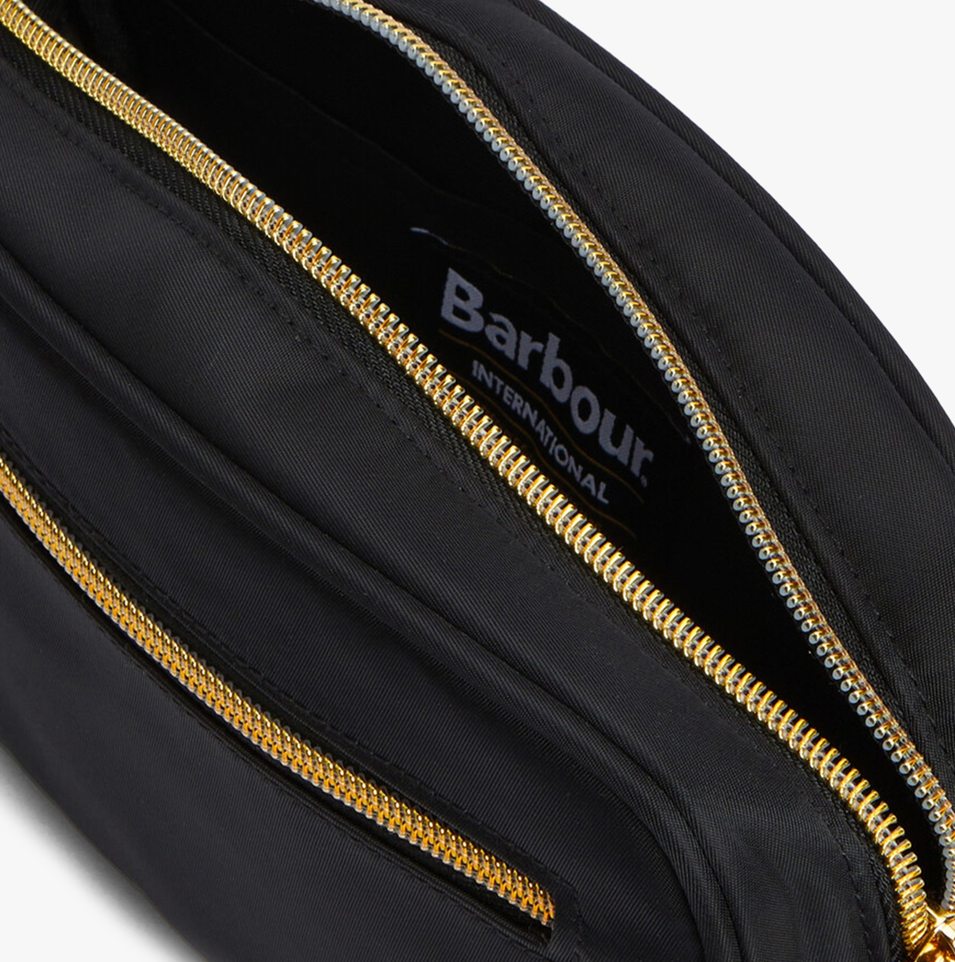 Barbour B.INTL MICRO QUALIFY Womens Crossbody Bag Black detail view showing interior zippers and branded label.