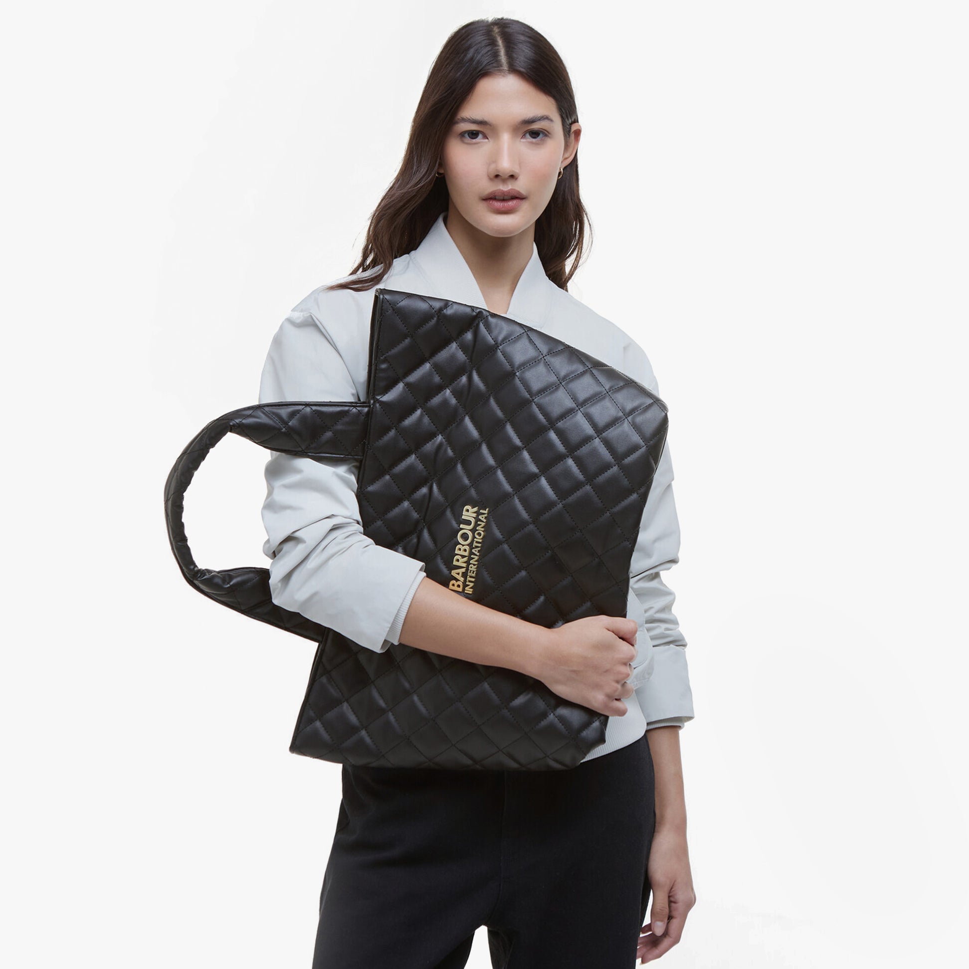 Barbour B.INTL BATTERSEA QUILTED Womens Mini Tote Bag Black, front view, held by model, featuring quilted design and branding.