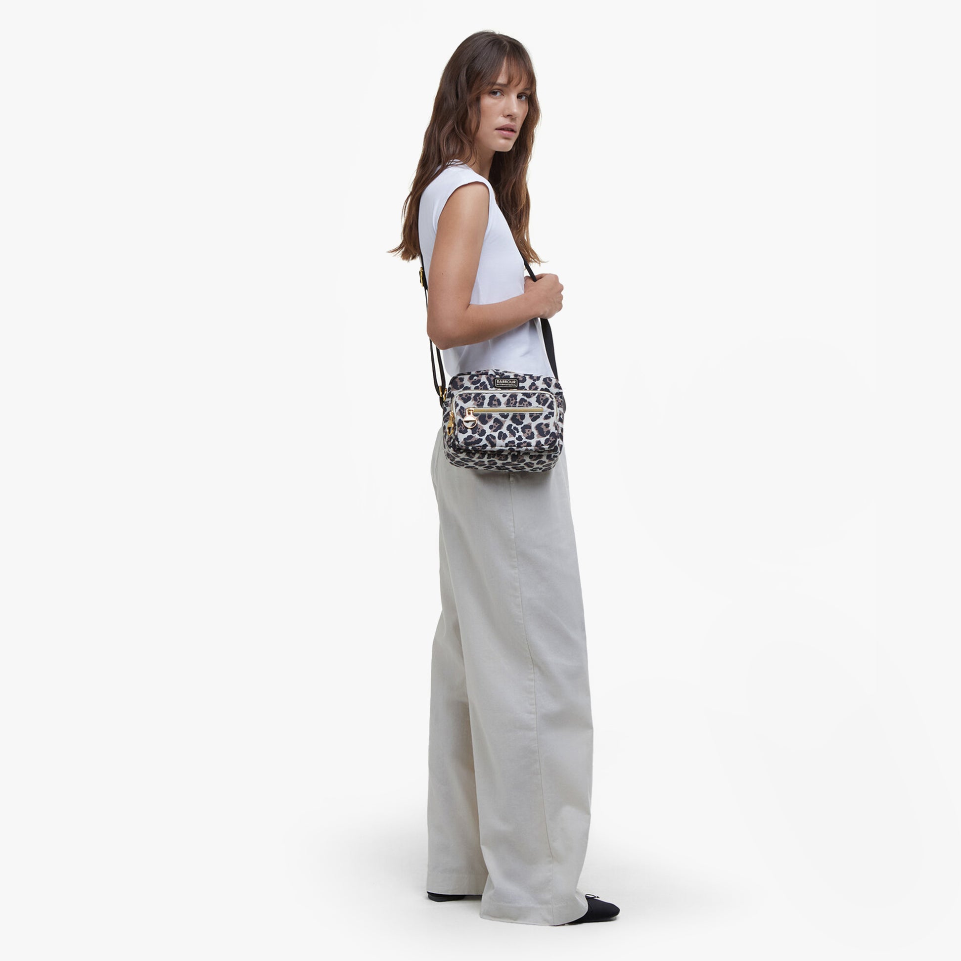 Barbour B.INTL BOULEVARD Womens Crossbody Bag Pearl Jaguar side view with model wearing it, showcasing lightweight nylon material.