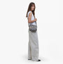 Barbour B.INTL BOULEVARD Womens Crossbody Bag Pearl Jaguar side view with model wearing it, showcasing lightweight nylon material.