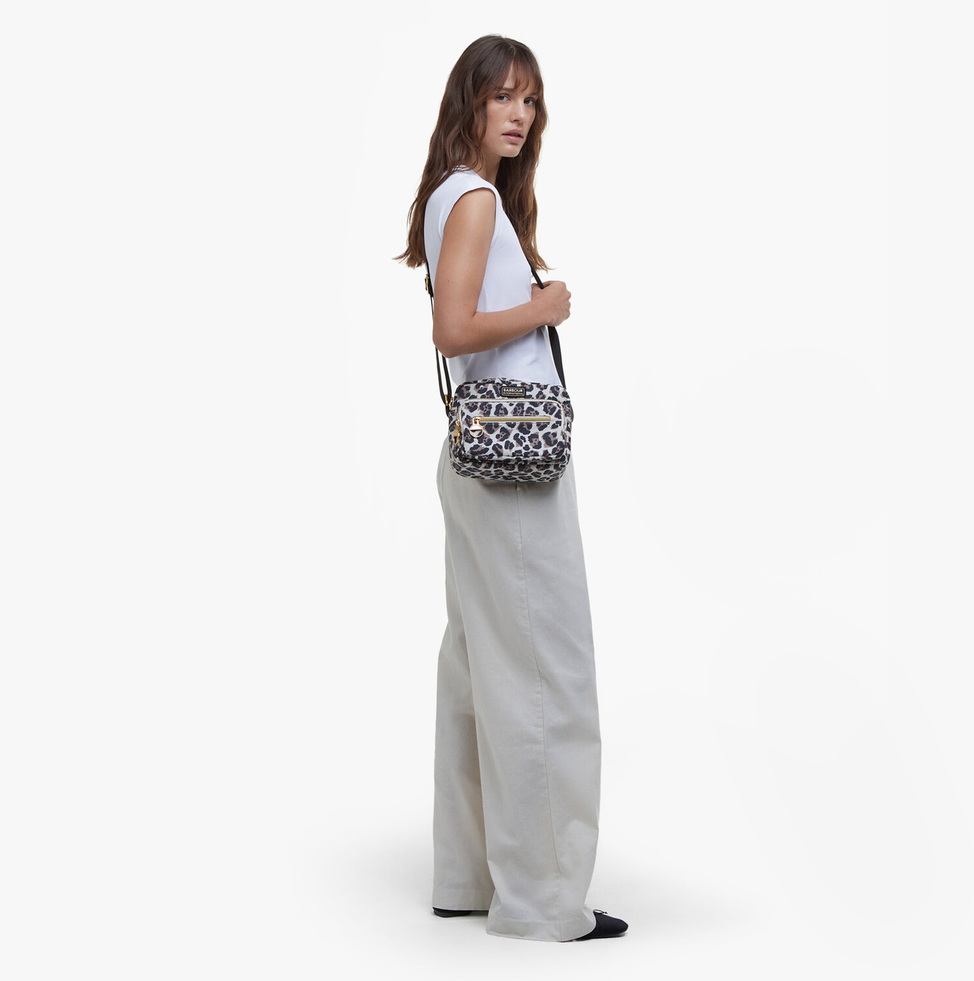 Barbour B.INTL BOULEVARD Womens Crossbody Bag Pearl Jaguar side view with model wearing it, showcasing lightweight nylon material.
