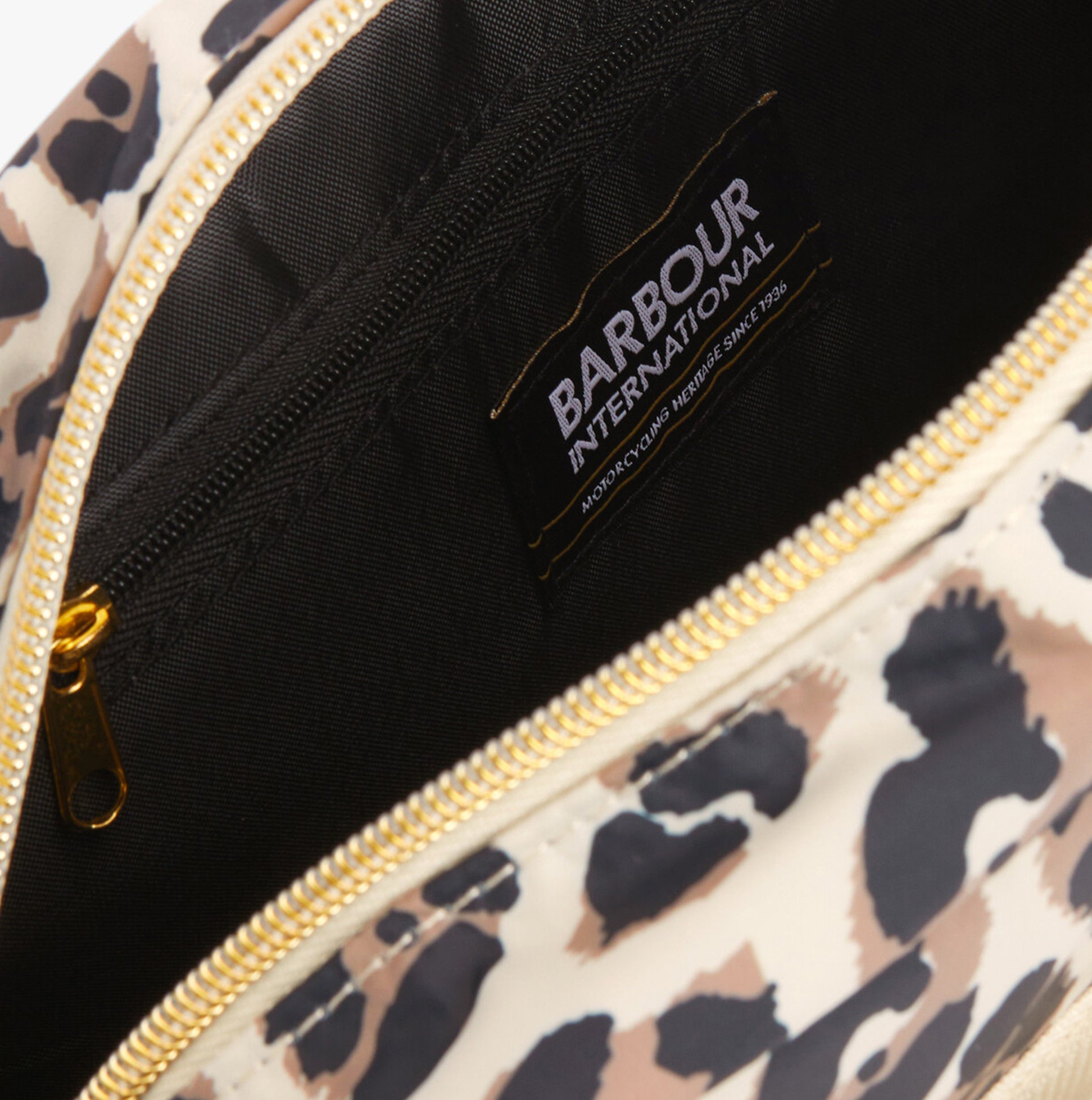 Barbour B.INTL BOULEVARD Womens Crossbody Bag Pearl Jaguar interior view with branded tag and zip closure.