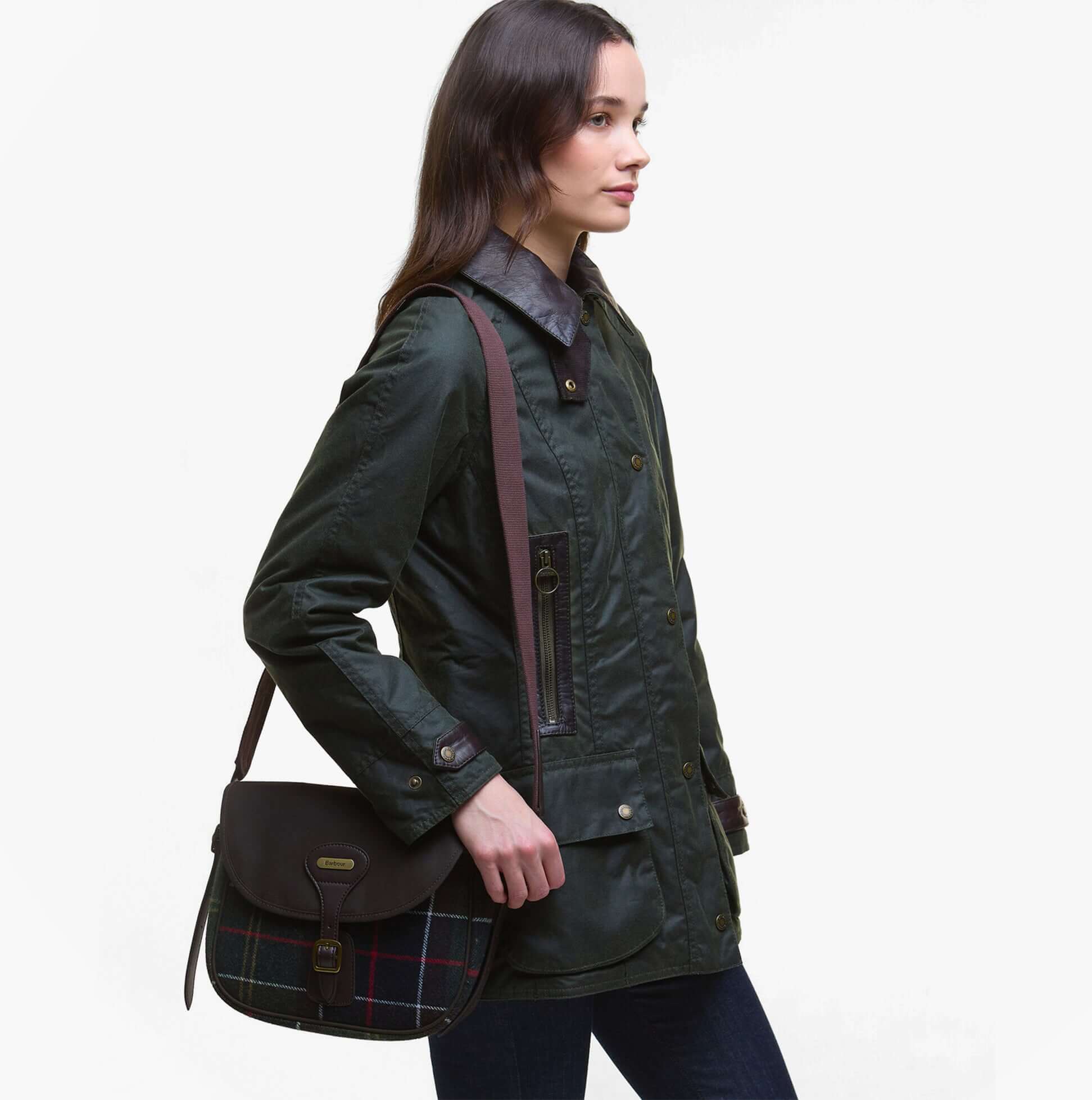 Barbour CROMARTY Crossbody Bag Womens Classic Tartan, side view model wearing the bag with a jacket, featuring tartan pattern.