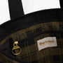 Interior detail view of Barbour MYA PATCHWORK Tote Bag Womens Tote Bag Black/Olive Check showing zip pocket and logo.