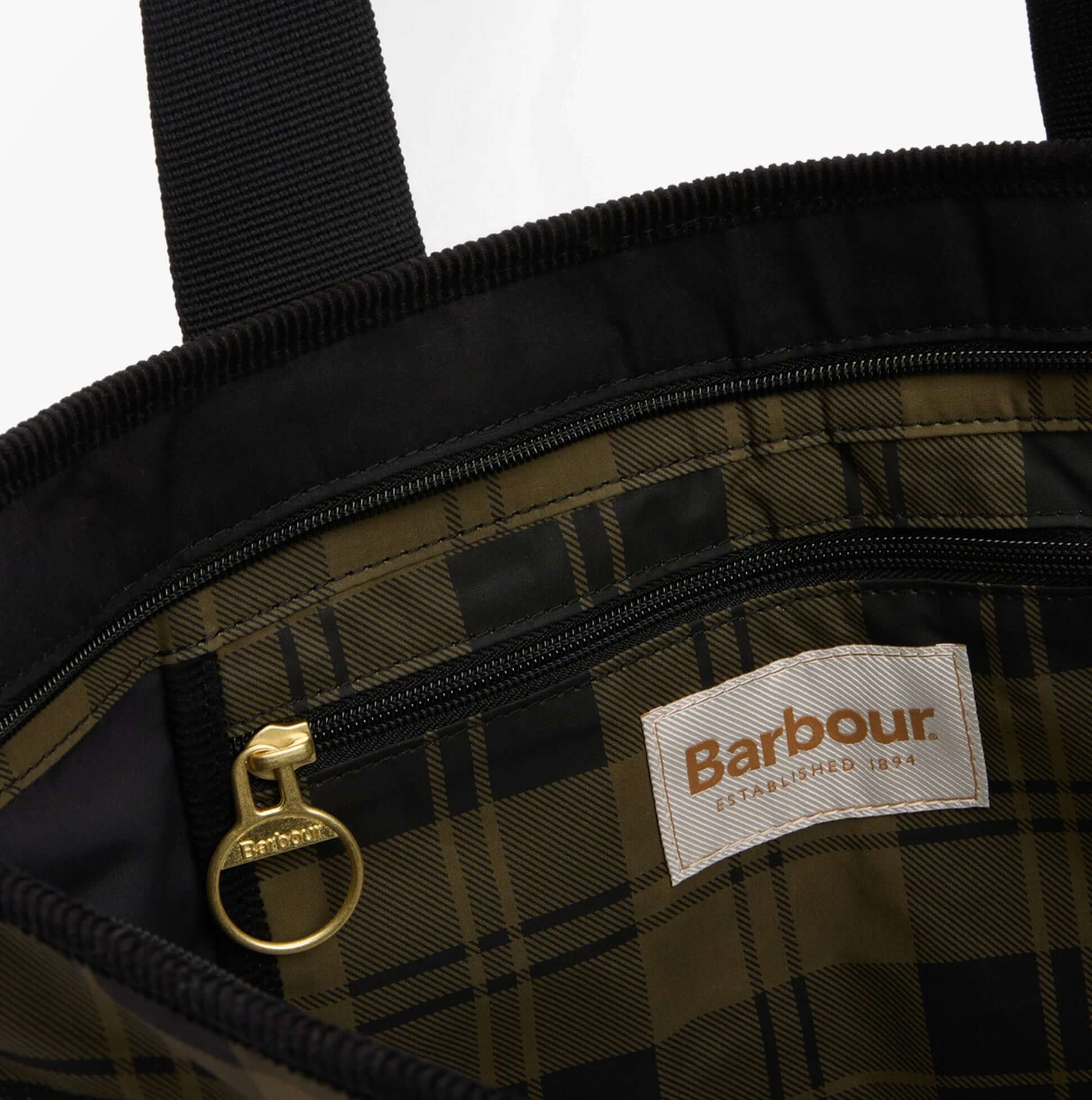Interior detail view of Barbour MYA PATCHWORK Tote Bag Womens Tote Bag Black/Olive Check showing zip pocket and logo.