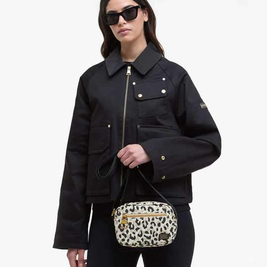 Barbour BOULEVARD MICRO Crossbody Bag Womens Jasmine Leopard front view with model in black jacket and sunglasses.