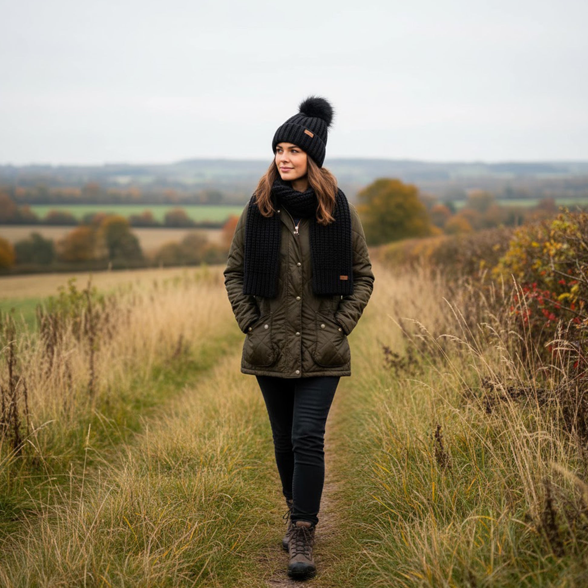 Barbour SALTBURN BEANIE & SCARF Womens Gift Set Black worn by model in countryside with black beanie and scarf.