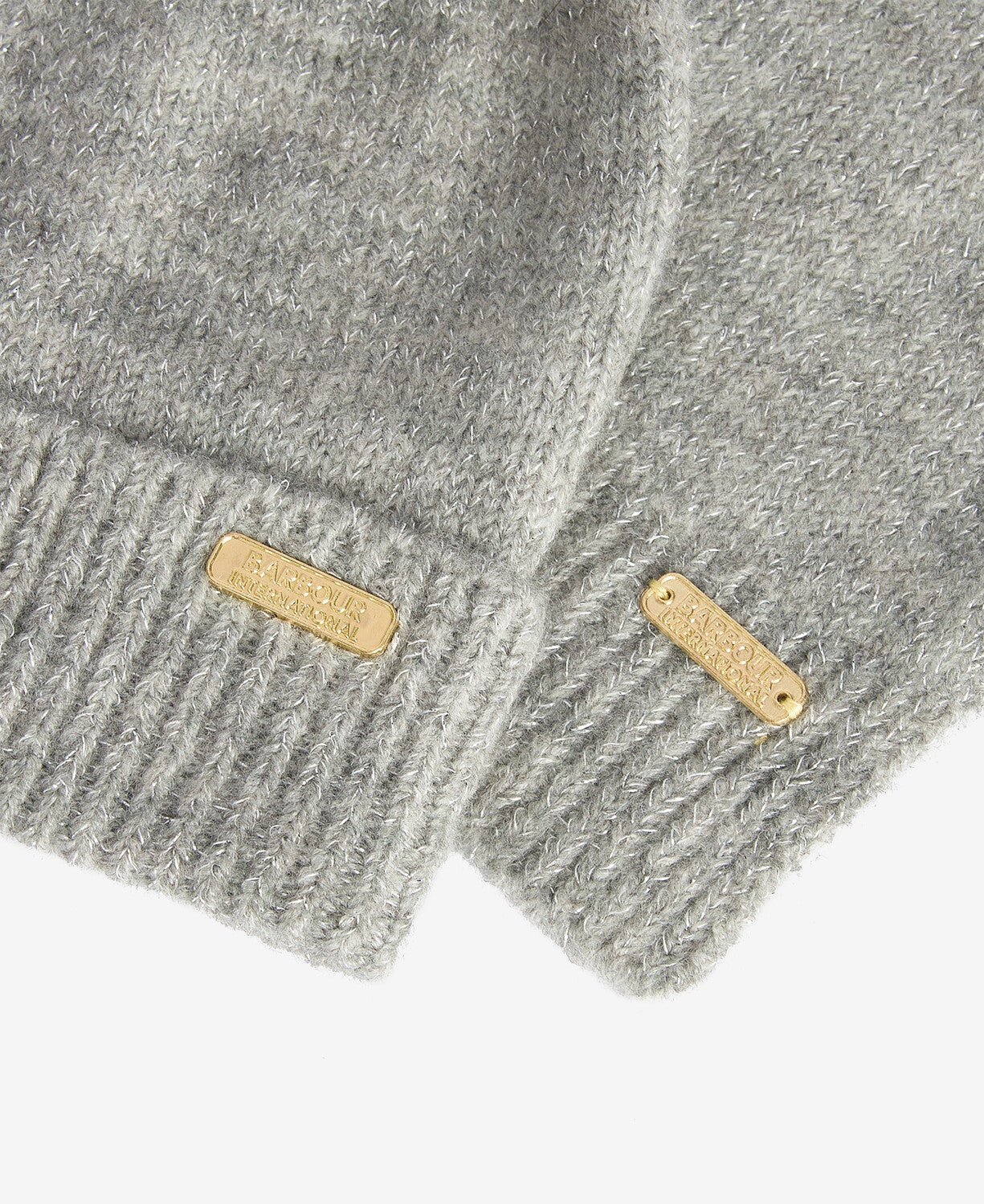 Barbour SPARKLE BEANIE & SCARF Womens Gift Set Grey Marl detail view showcasing gold labels on soft grey fabric.