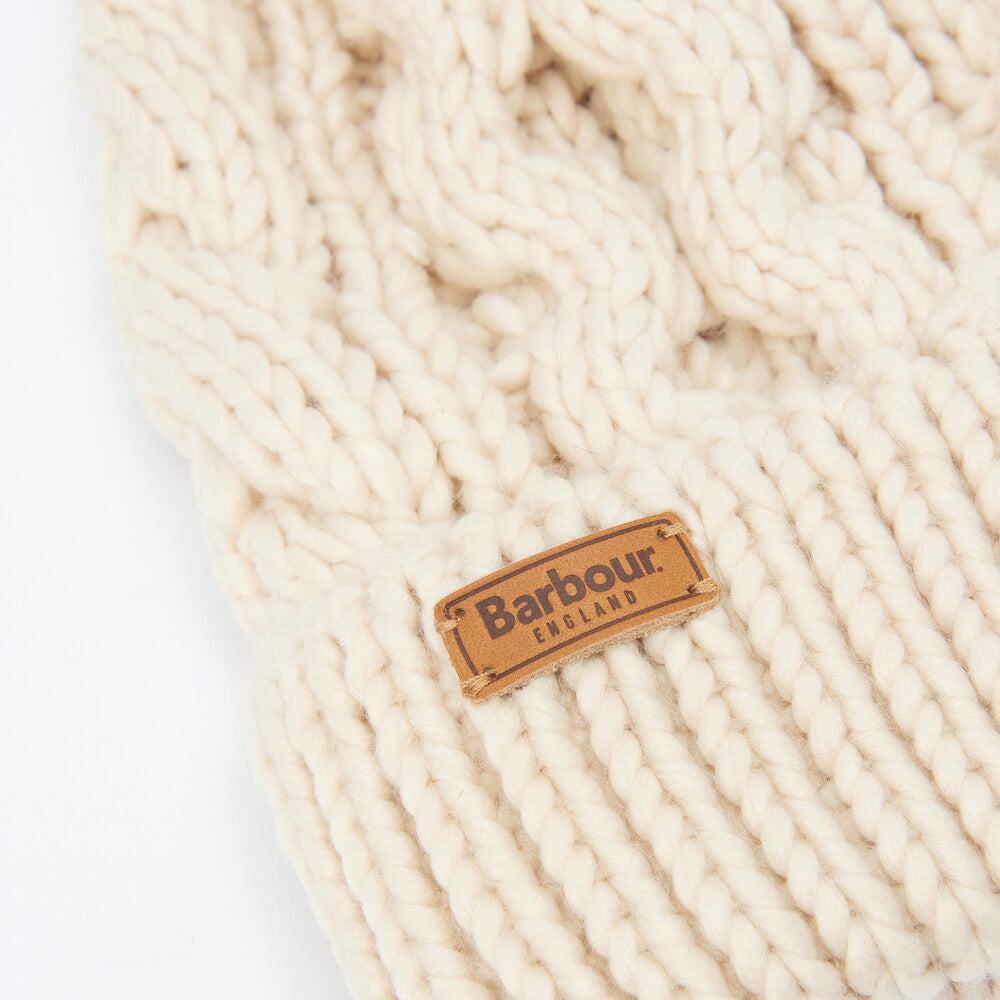 Barbour PENSHAW Womens Pom-Pom Beanie Blush Pink detail view showing cable-knit structure and logo-embossed leather badge.