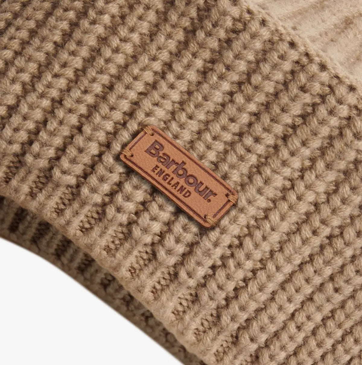 Detail view of Barbour BELDON BERET Womens Beanie Honey with brand label tag.