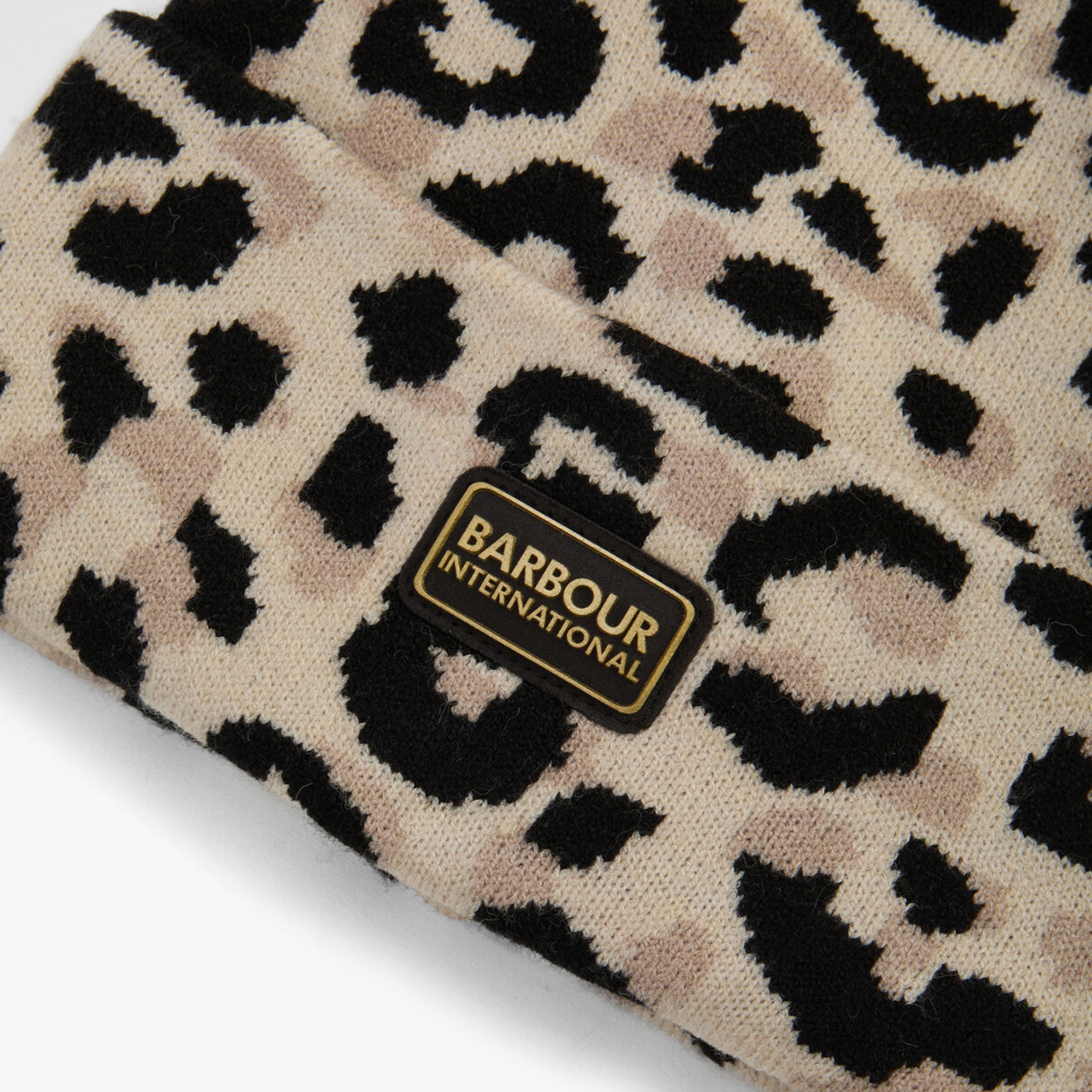 Barbour HARLEY LEOPARD Womens Beanie Jasmine Leopard detail view showcasing leopard print pattern and logo.