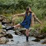 Barbour BEDE Womens Tall Wellies Black worn by a model in a stream, side view, showcasing waterproof style and comfort.