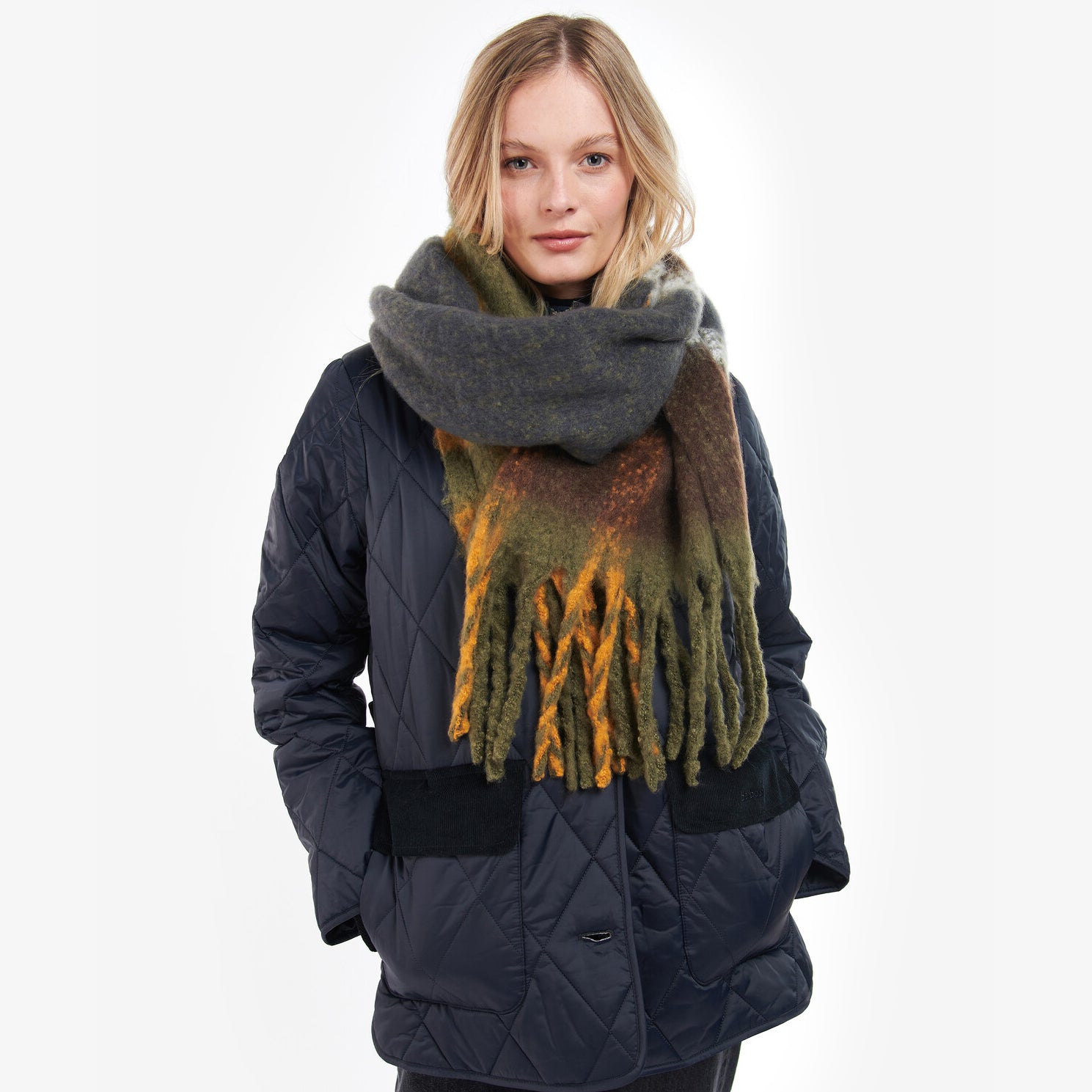 Barbour ISLA TARTAN BOUCLE Scarf Womens Classic worn by model, front view, showcasing all-over tartan pattern and XL tasselled trims.