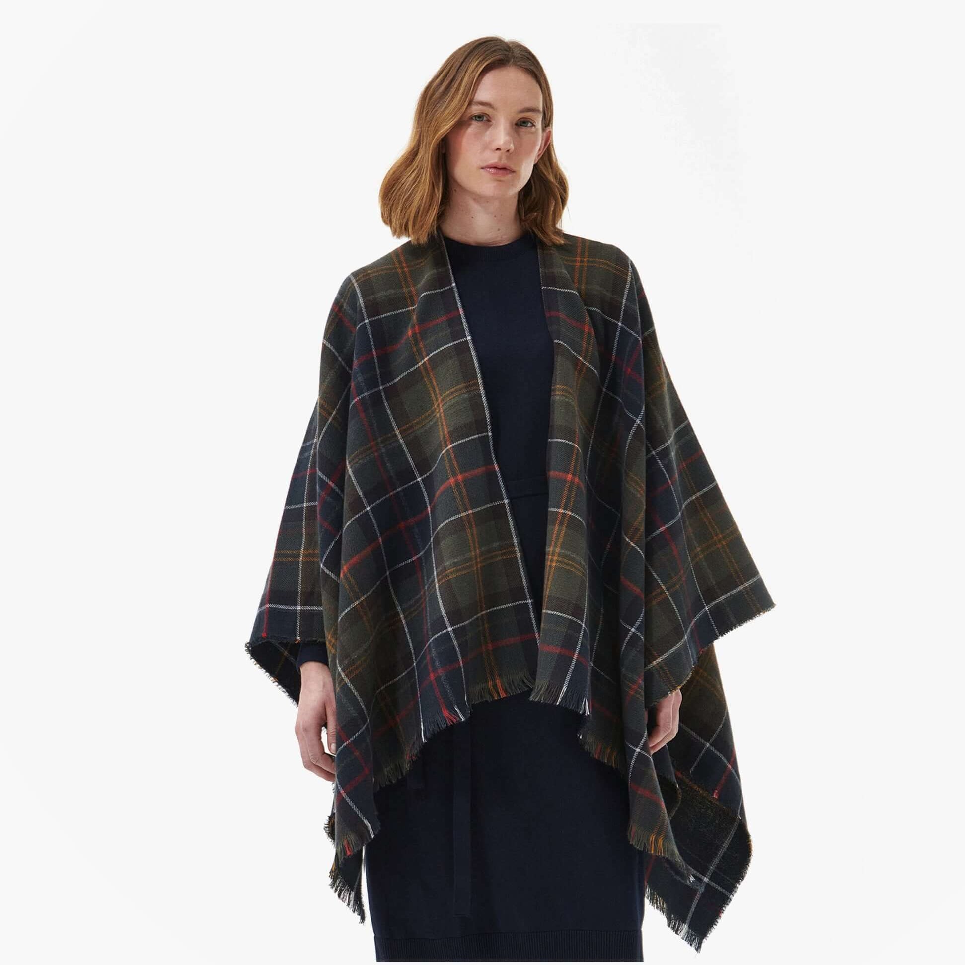 Barbour MONTIETH SERAPE Womens Scarf Classic front view in dark plaid design, featuring fringed edges, styled over a navy dress.