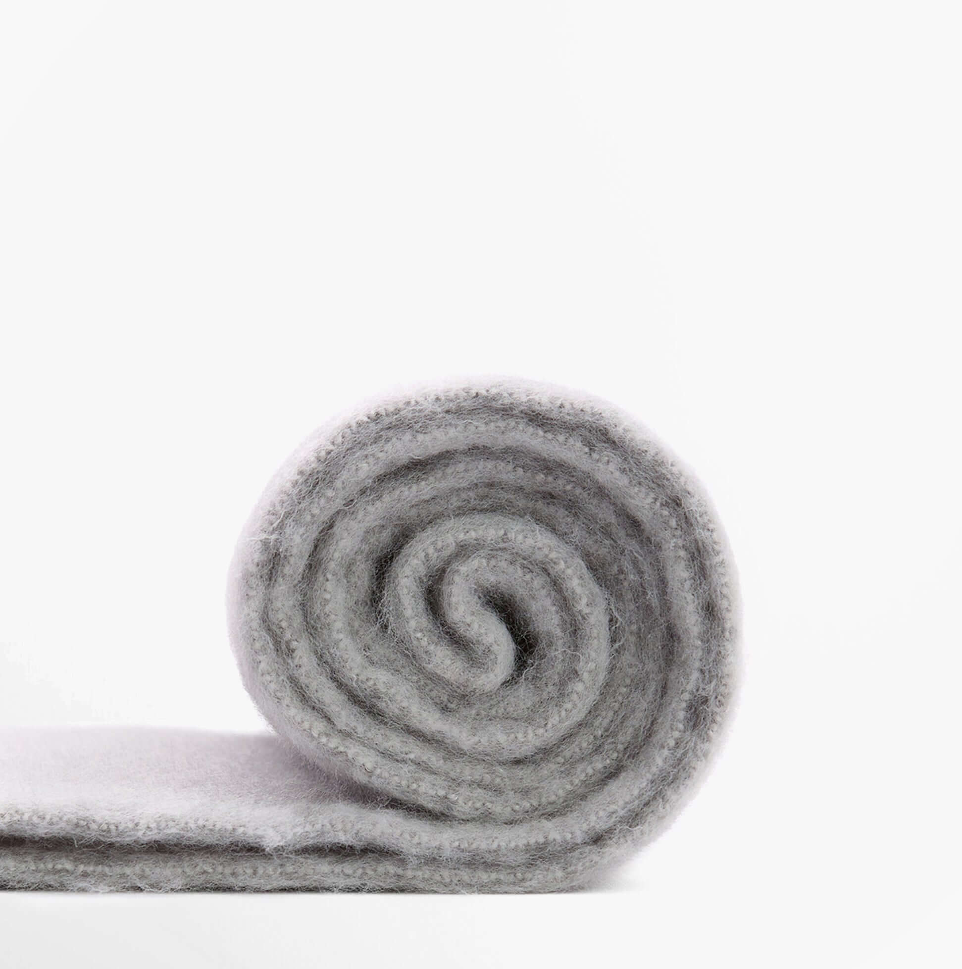 Barbour ELLISON Womens Winter Light Grey rolled scarf viewed from the side, showcasing its soft texture and color.