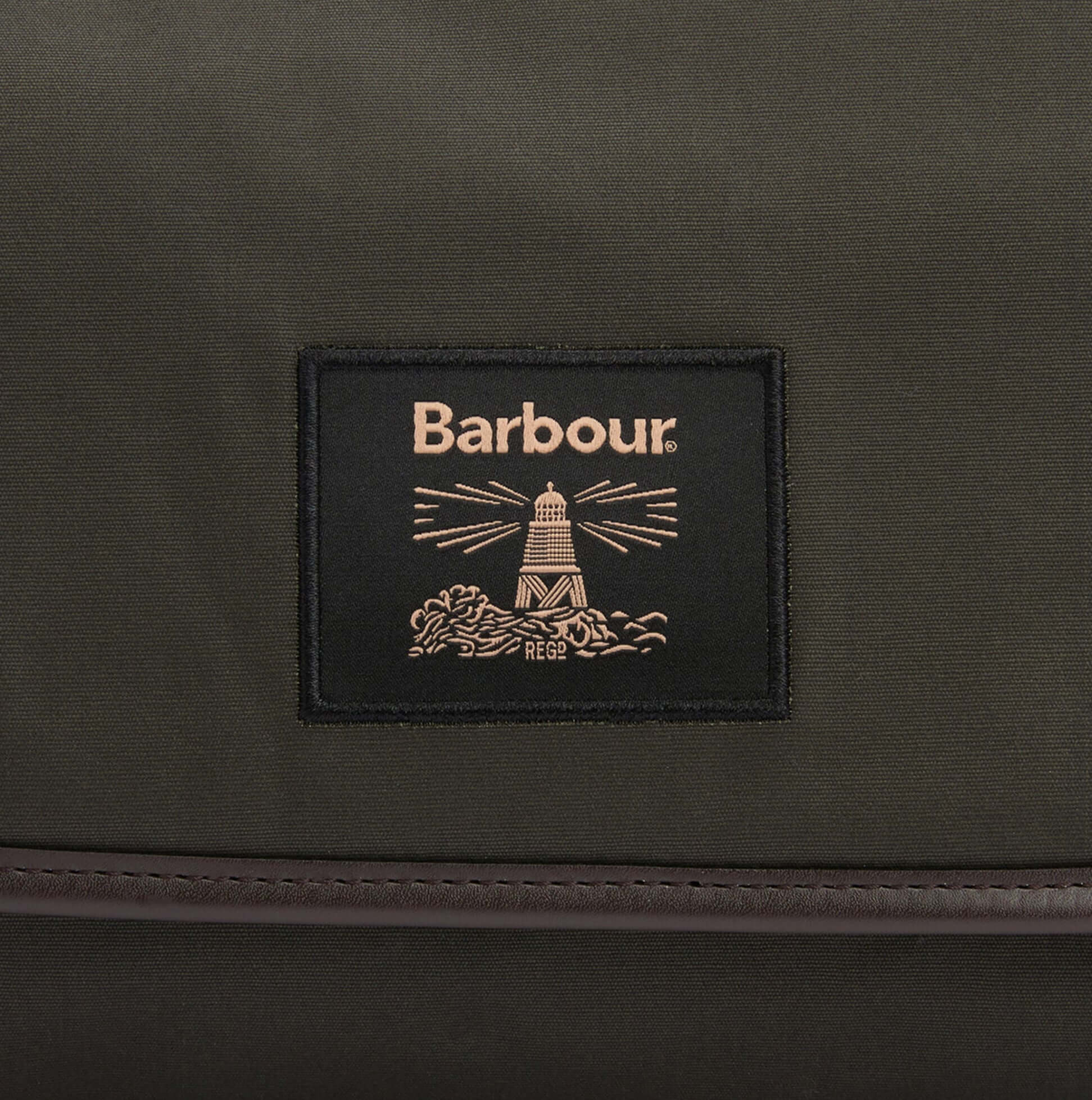 Barbour WAXED HANGING Mens Washbag Olive/Beacon logo detail view on dark green fabric.