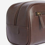Barbour LEATHER Mens Wash Bag Dark Brown side view showcasing the zip closure and natural grained finish.